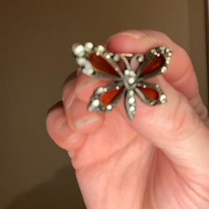 Orange butterfly pin with silver gems.